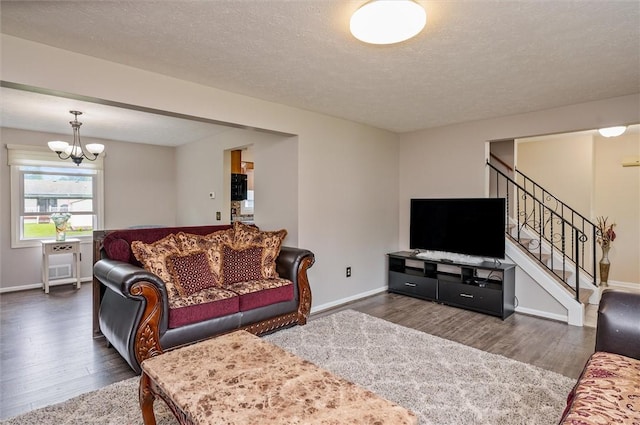 73 Hazel Bark Run, Gates, NY 14606 - living room with wood finished floors, stairway, a chandelier, and a textured ceiling