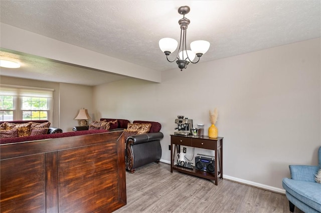 73 Hazel Bark Run, Gates, NY 14606 - living room featuring light wood-style flooring, a chandelier, and a textured ceiling