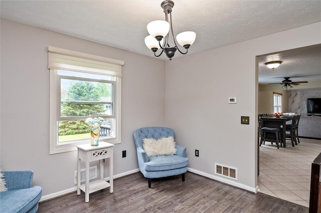 73 Hazel Bark Run, Gates, NY 14606 - sitting room featuring a chandelier, wood finished floors, ceiling fan, and a textured ceiling