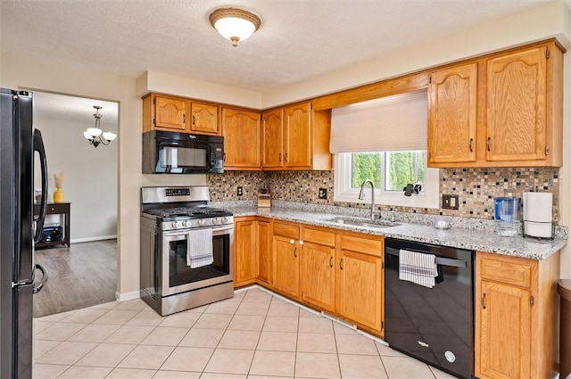 73 Hazel Bark Run, Gates, NY 14606 - kitchen with black appliances, backsplash, a chandelier, light tile patterned floors, and light stone countertops