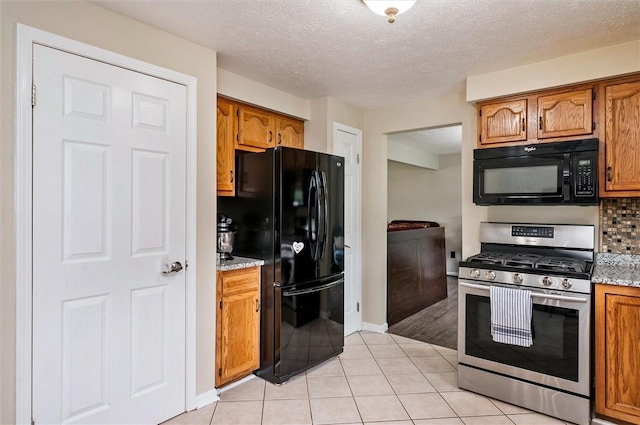 73 Hazel Bark Run, Gates, NY 14606 - kitchen featuring black appliances, brown cabinetry, light tile patterned floors, tasteful backsplash, and a textured ceiling