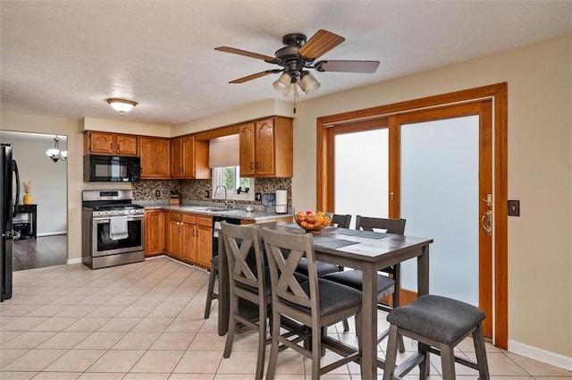 73 Hazel Bark Run, Gates, NY 14606 - kitchen featuring black appliances, brown cabinetry, backsplash, a ceiling fan, and light tile patterned flooring