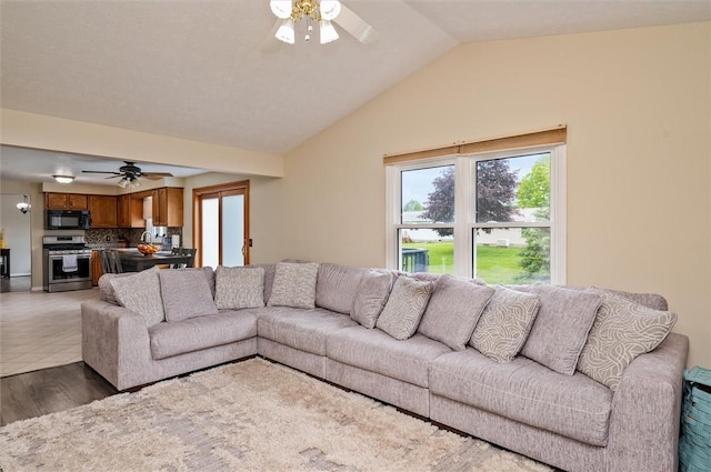 73 Hazel Bark Run, Gates, NY 14606 - living room featuring a ceiling fan, vaulted ceiling, and light wood finished floors
