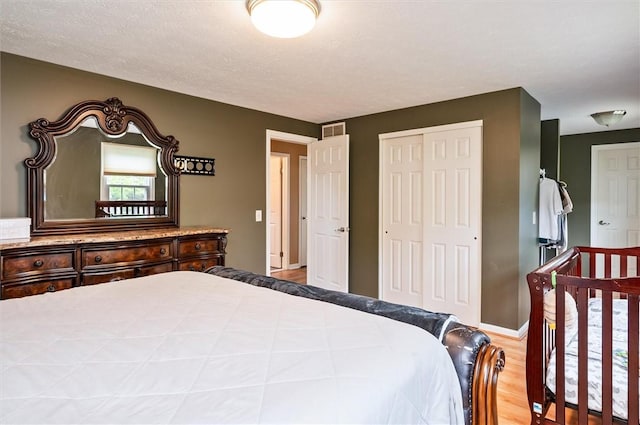 73 Hazel Bark Run, Gates, NY 14606 - bedroom featuring wood finished floors and a closet