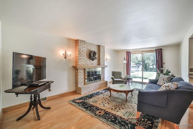 79 Pin Oak Cir, Grand Island, NY 14072 - living area featuring wood finished floors and a fireplace