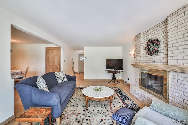 79 Pin Oak Cir, Grand Island, NY 14072 - living area featuring wood finished floors and a brick fireplace