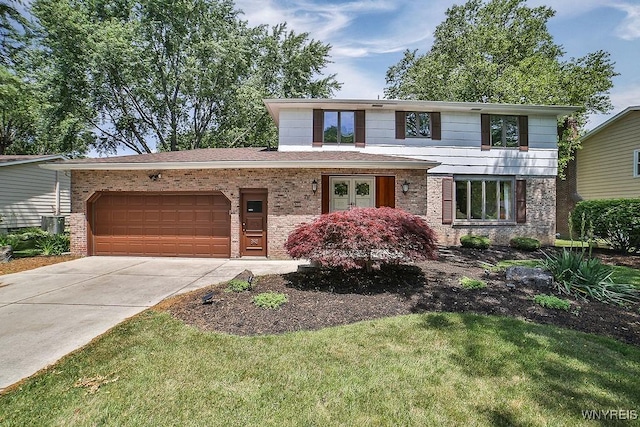 79 Pin Oak Cir, Grand Island, NY 14072 - view of front of home featuring brick siding, an attached garage, concrete driveway, and a front lawn