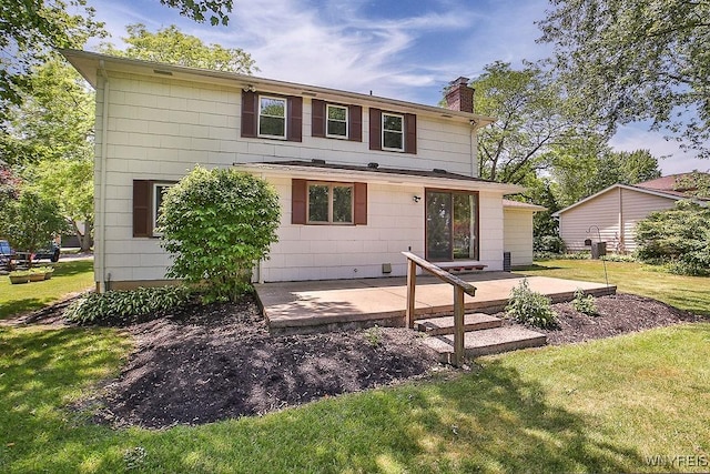 79 Pin Oak Cir, Grand Island, NY 14072 - rear view of property featuring a chimney, a yard, and a patio area