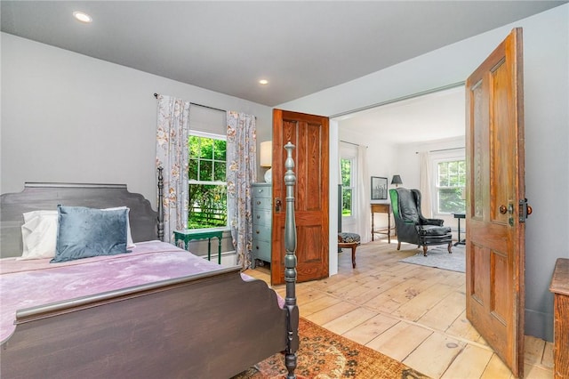 2465 Turk Hill Rd, Perinton, NY 14564 - bedroom featuring light wood-type flooring, multiple windows, recessed lighting, and baseboard heating