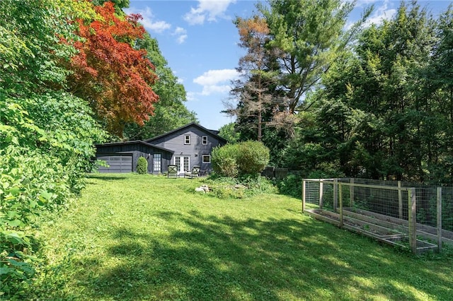2465 Turk Hill Rd, Perinton, NY 14564 - view of yard featuring a vegetable garden and an attached garage