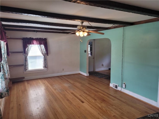 15 Beaver St, Manheim, NY 13329 - unfurnished room featuring arched walkways, beam ceiling, wood-type flooring, and a ceiling fan