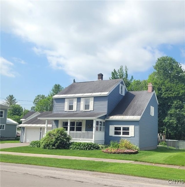 15 Beaver St, Manheim, NY 13329 - traditional-style house with a porch, a chimney, driveway, and an attached garage