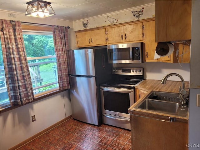 15 Beaver St, Manheim, NY 13329 - kitchen featuring appliances with stainless steel finishes, plenty of natural light, brick patterned floors, ornamental molding, and light countertops