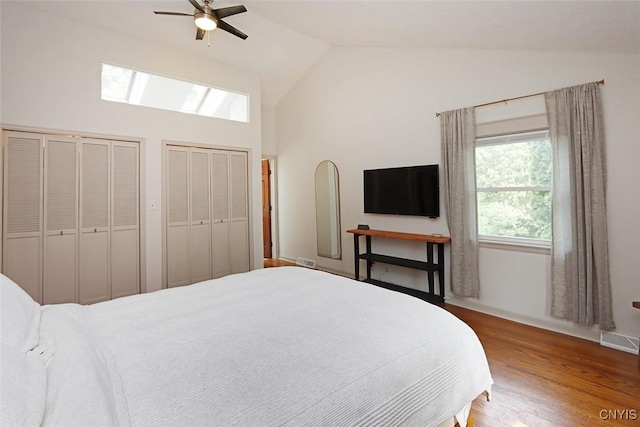 105 Maple Dr, Dewitt, NY 13066 - bedroom featuring a skylight, multiple closets, high vaulted ceiling, wood finished floors, and ceiling fan