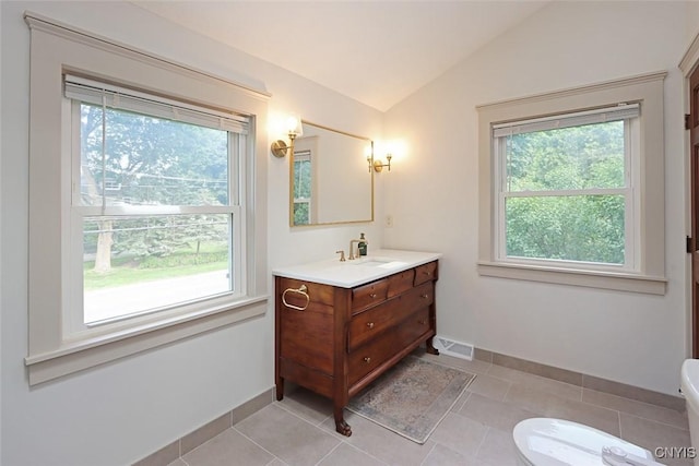 105 Maple Dr, Dewitt, NY 13066 - bathroom with plenty of natural light, vanity, lofted ceiling, and tile patterned floors
