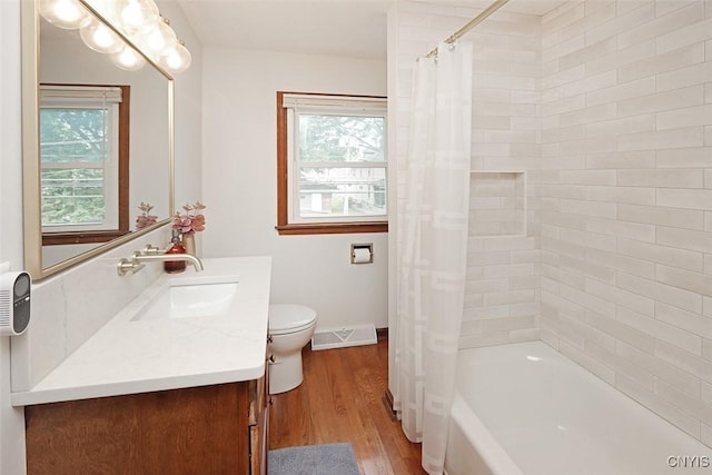 105 Maple Dr, Dewitt, NY 13066 - full bathroom with vanity, wood finished floors, and shower / bath combo with shower curtain