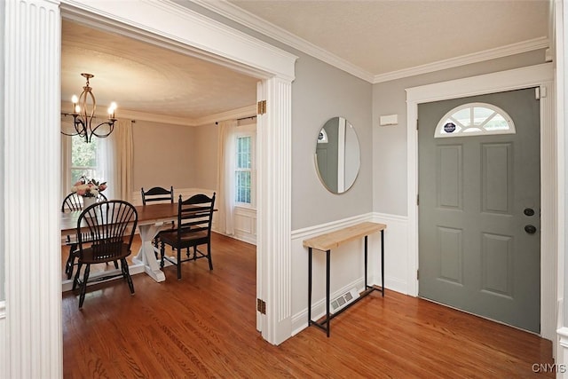 105 Maple Dr, Dewitt, NY 13066 - entryway with a chandelier, healthy amount of natural light, wood finished floors, and ornamental molding