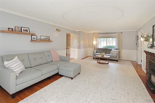 105 Maple Dr, Dewitt, NY 13066 - living room with ornamental molding, a wainscoted wall, wood finished floors, and a brick fireplace