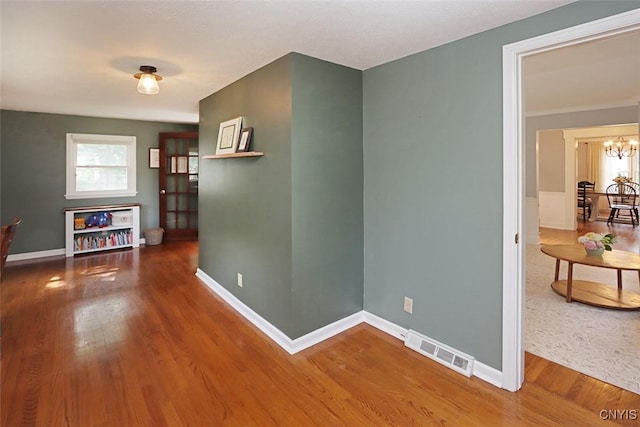 105 Maple Dr, Dewitt, NY 13066 - corridor with a chandelier and wood finished floors