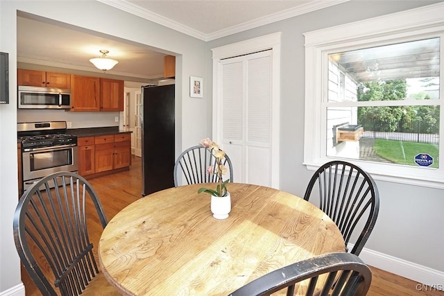 105 Maple Dr, Dewitt, NY 13066 - dining room featuring wood finished floors and crown molding