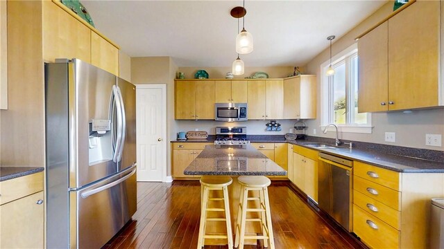 3409 Fieldstone Ln, Erwin, NY 14870 - kitchen with stainless steel appliances, a center island, dark wood-style floors, and a breakfast bar