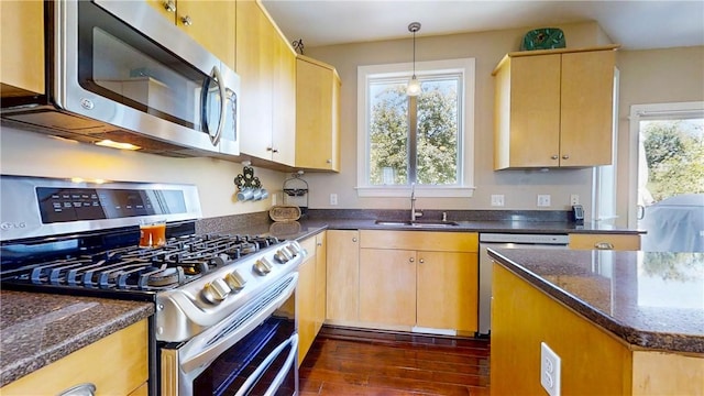 3409 Fieldstone Ln, Erwin, NY 14870 - kitchen featuring stainless steel appliances, dark stone countertops, dark wood finished floors, decorative light fixtures, and light brown cabinetry