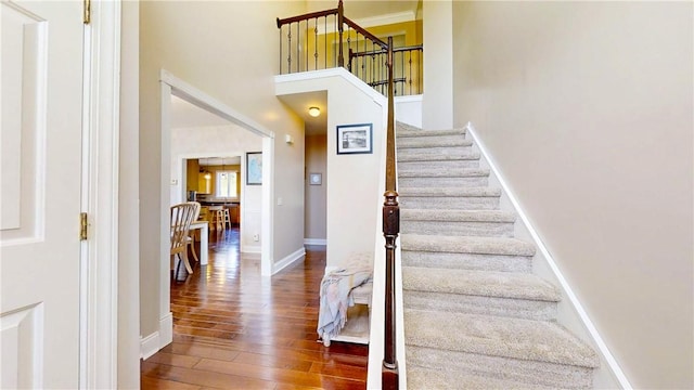 3409 Fieldstone Ln, Erwin, NY 14870 - staircase featuring wood finished floors and a high ceiling