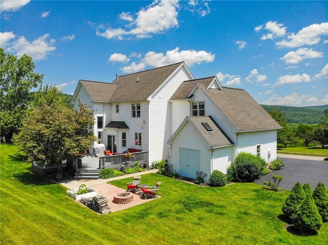 3409 Fieldstone Ln, Erwin, NY 14870 - back of property with an outdoor fire pit, a deck, a patio, and a yard