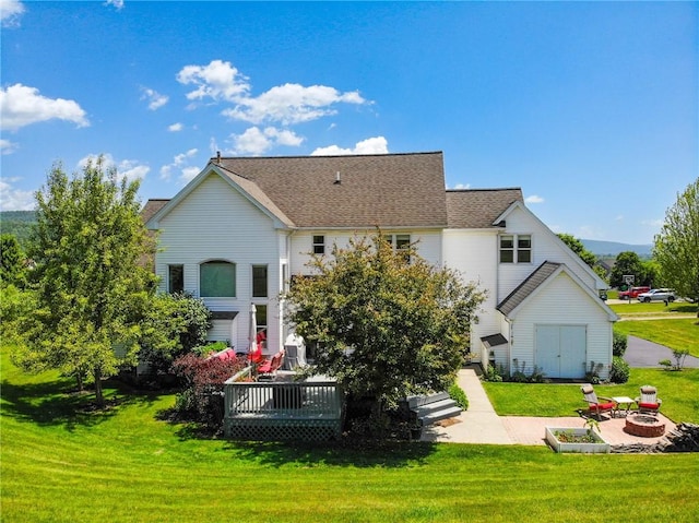 3409 Fieldstone Ln, Erwin, NY 14870 - back of property featuring a fire pit, a yard, a deck, a patio area, and a shingled roof