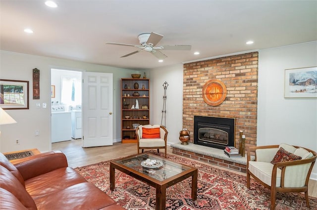 11 Keystone Ct, Sweden, NY 14420 - living area featuring recessed lighting, a ceiling fan, light wood-style flooring, ornamental molding, and a fireplace