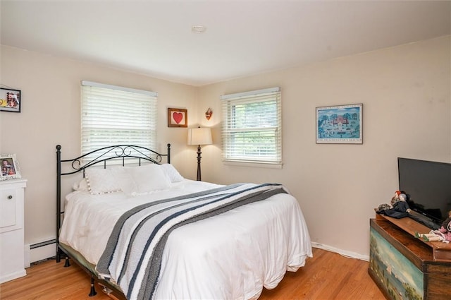 11 Keystone Ct, Sweden, NY 14420 - bedroom with baseboard heating and wood finished floors