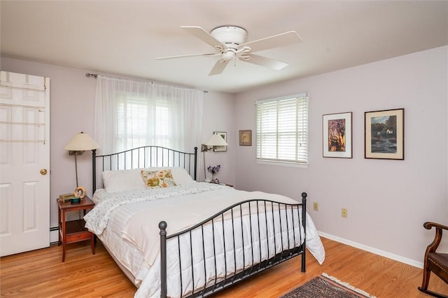 11 Keystone Ct, Sweden, NY 14420 - bedroom featuring wood finished floors, baseboard heating, and ceiling fan