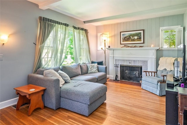 1463 Lehigh Station Rd, Henrietta, NY 14467 - living area featuring beam ceiling, wood finished floors, and a fireplace