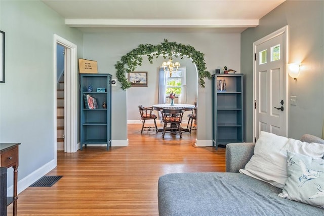 1463 Lehigh Station Rd, Henrietta, NY 14467 - living area with a chandelier, beamed ceiling, and wood finished floors