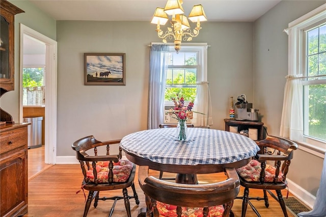 1463 Lehigh Station Rd, Henrietta, NY 14467 - dining space featuring light wood-style floors and a chandelier