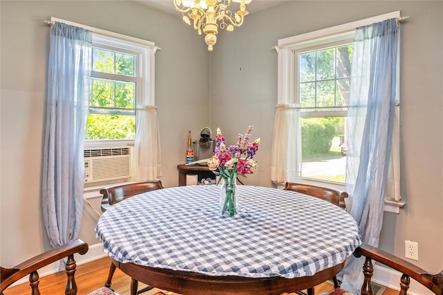 1463 Lehigh Station Rd, Henrietta, NY 14467 - dining room with plenty of natural light, wood finished floors, a chandelier, and cooling unit