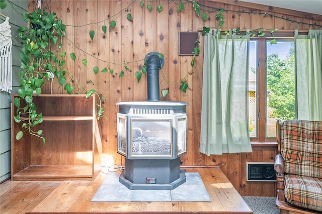 1463 Lehigh Station Rd, Henrietta, NY 14467 - detailed view of a wood stove, wooden walls, and wood finished floors