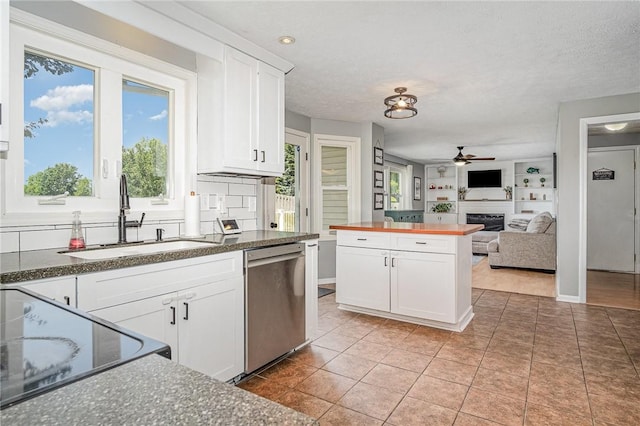3487 Scenic Way, Walworth, NY 14502 - kitchen featuring stainless steel dishwasher, butcher block counters, a fireplace, ceiling fan, and white cabinets