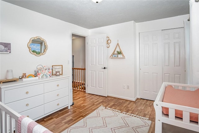3487 Scenic Way, Walworth, NY 14502 - bedroom featuring wood finished floors, a closet, and a textured ceiling