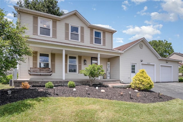3487 Scenic Way, Walworth, NY 14502 - view of front of home with a porch, asphalt driveway, an attached garage, and a front lawn