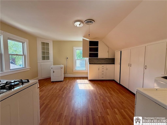 118 S 8th St, Olean-City, NY 14760 - kitchen with washer / clothes dryer, healthy amount of natural light, light wood-style floors, white gas stove, and vaulted ceiling