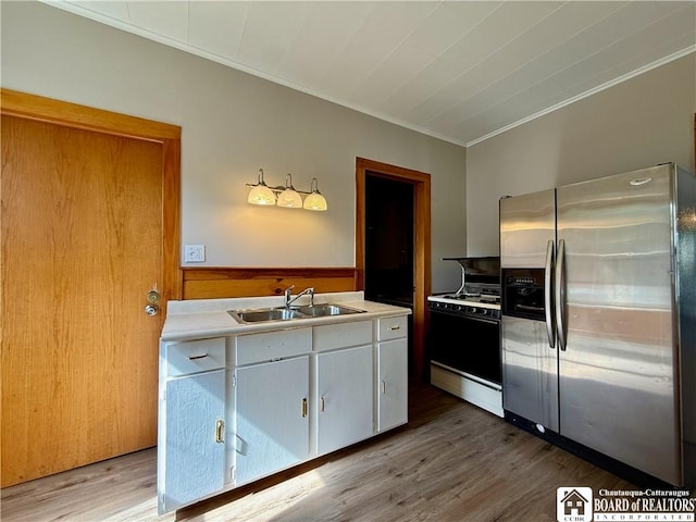 118 S 8th St, Olean-City, NY 14760 - kitchen with stainless steel fridge, white range with gas stovetop, crown molding, wood finished floors, and light countertops