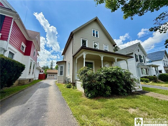 118 S 8th St, Olean-City, NY 14760 - view of front facade with covered porch, a front lawn, and a detached garage