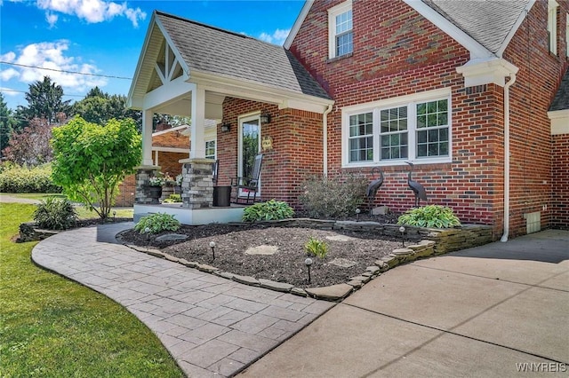 4964 Meadowbrook Rd, Clarence, NY 14221 - view of front of property with brick siding, a shingled roof, and covered porch