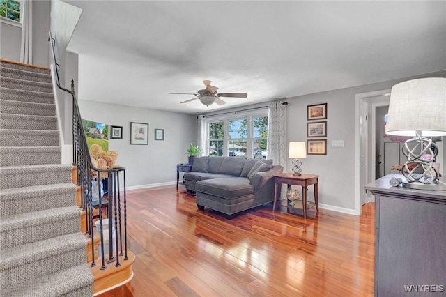 4964 Meadowbrook Rd, Clarence, NY 14221 - living room featuring a ceiling fan, light wood-style floors, and stairway