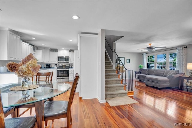 4964 Meadowbrook Rd, Clarence, NY 14221 - dining room with light wood-type flooring, ceiling fan, stairs, and recessed lighting