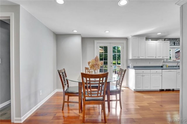 4964 Meadowbrook Rd, Clarence, NY 14221 - dining area with light wood finished floors, french doors, and recessed lighting