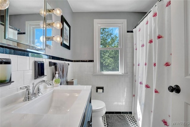 4964 Meadowbrook Rd, Clarence, NY 14221 - bathroom with tile walls, vanity, tile patterned floors, a shower with shower curtain, and wainscoting