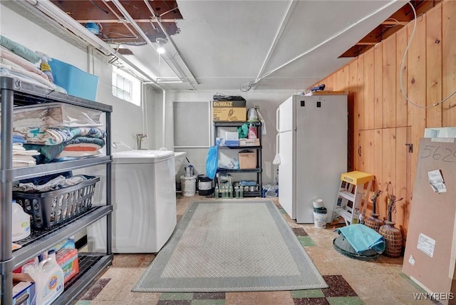 4964 Meadowbrook Rd, Clarence, NY 14221 - below grade area featuring freestanding refrigerator, wood walls, and washer / clothes dryer