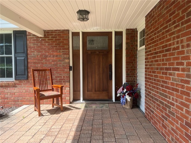 5 White Birch Cir, Chili, NY 14624 - doorway to property featuring brick siding and a porch